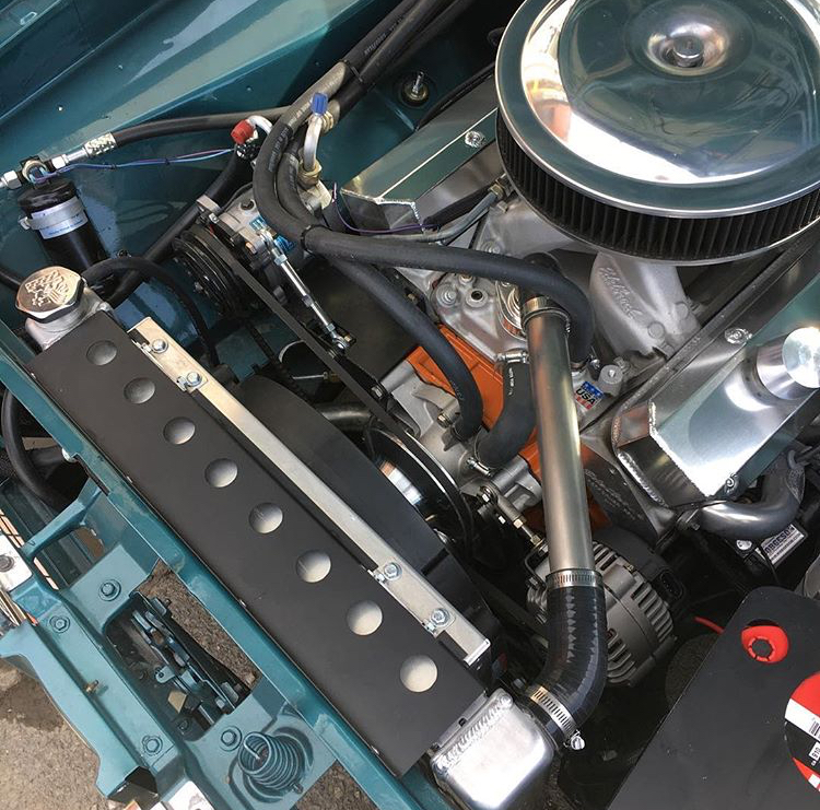 Custom radiator and shroud for an electric puller fan with a tight fit in a classic Mopar mucscle car. 